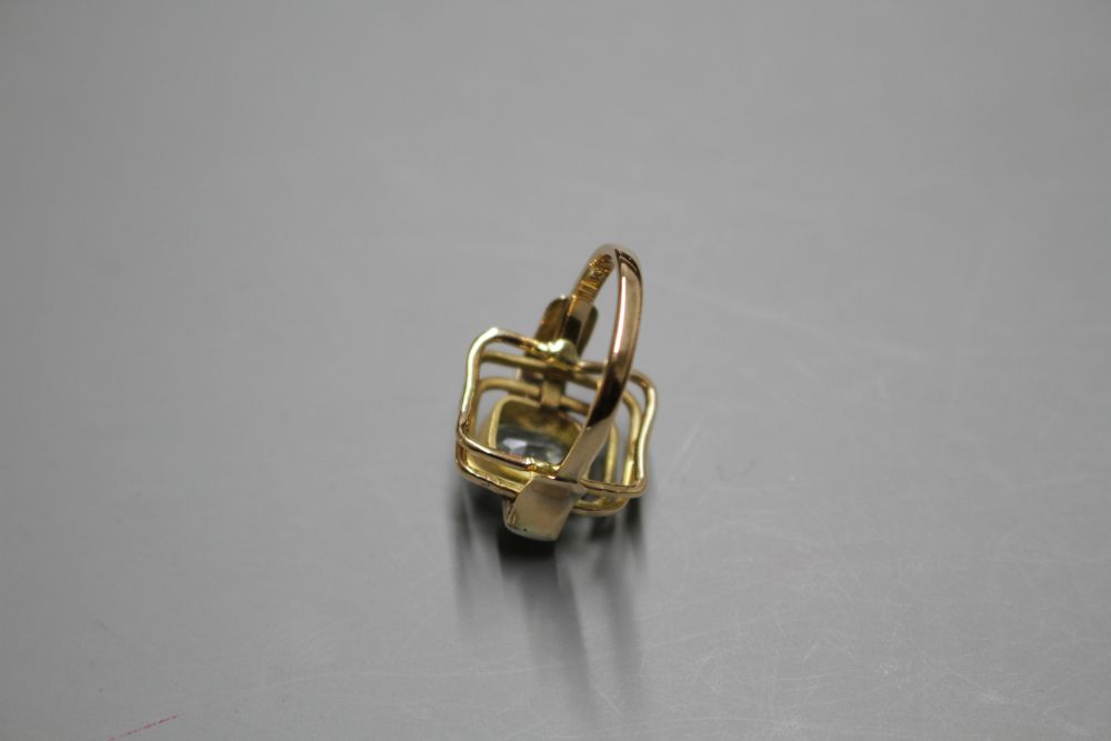 A 585 yellow metal, aquamarine and diamond set three stone dress ring, with pierced stepped setting,